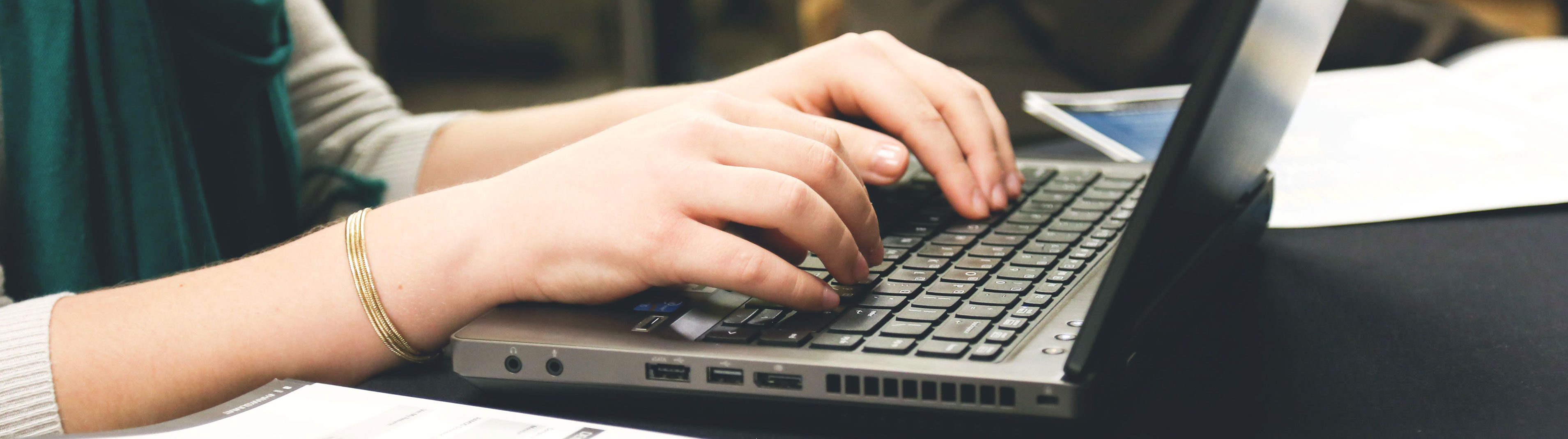 Student typing on a laptop.