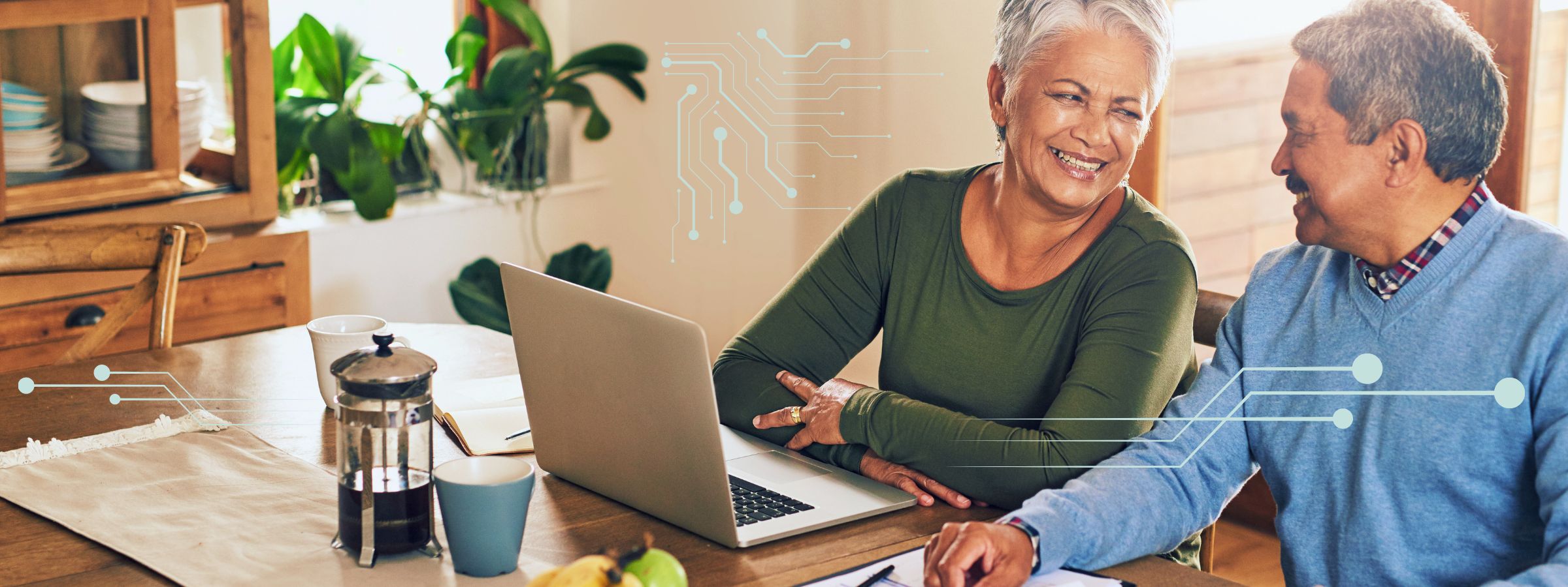 older adult couple, at home with laptop, graphic elements indicating a smart or connected home