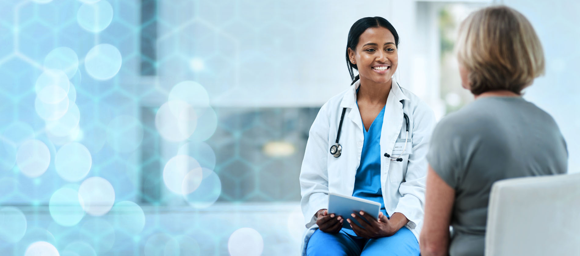 A doctor happily talking with a patient