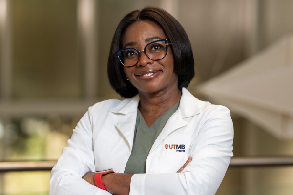 Professional Woman Wearing UTMB Logo Lab Coat