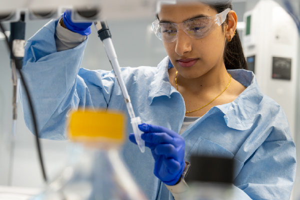 Professional Woman in a lab setting working with lab tools and samples